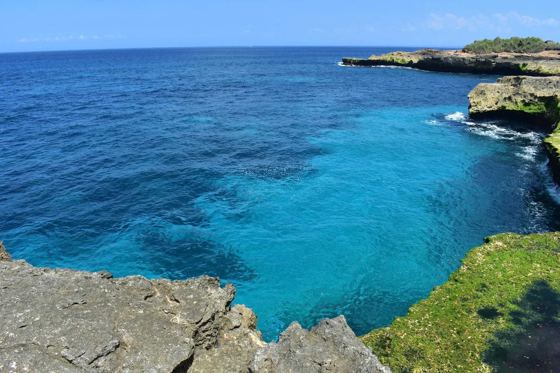 Cliff overlooking a deep blue cove on Long Island, Bahamas